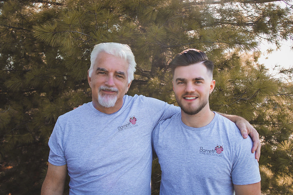 owners seth and wayne barrett pose together in front of a fern tree