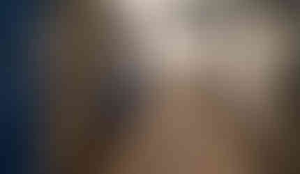 Weathered wood luxury vinyl flooring warmly grounds to the Azure blue and soft white cabinetry