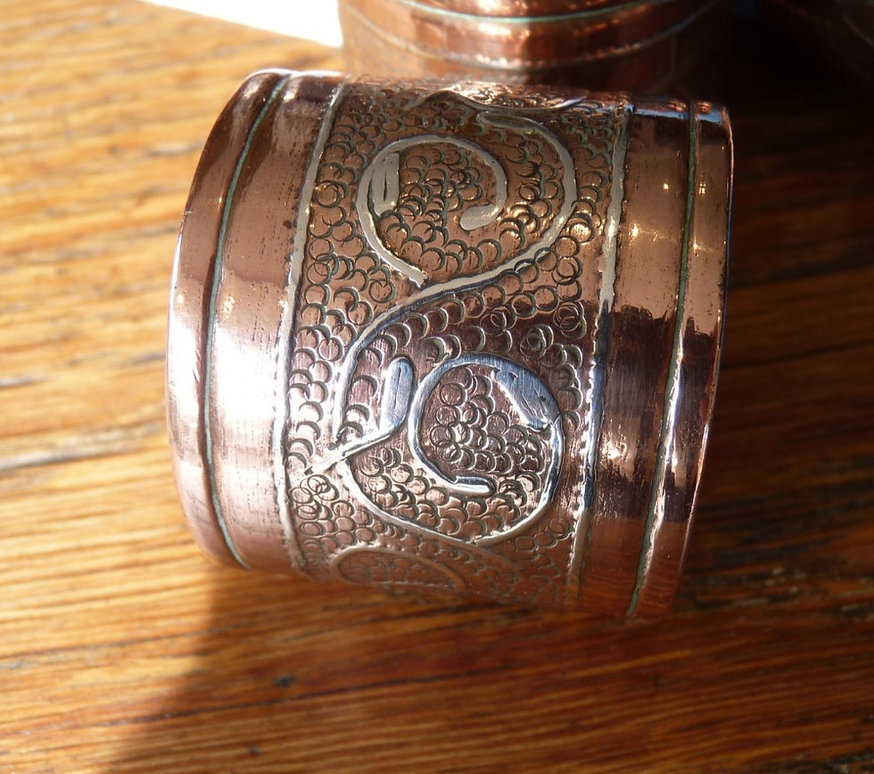 Thumbnail: Set of four copper napkin rings with inlaid silver