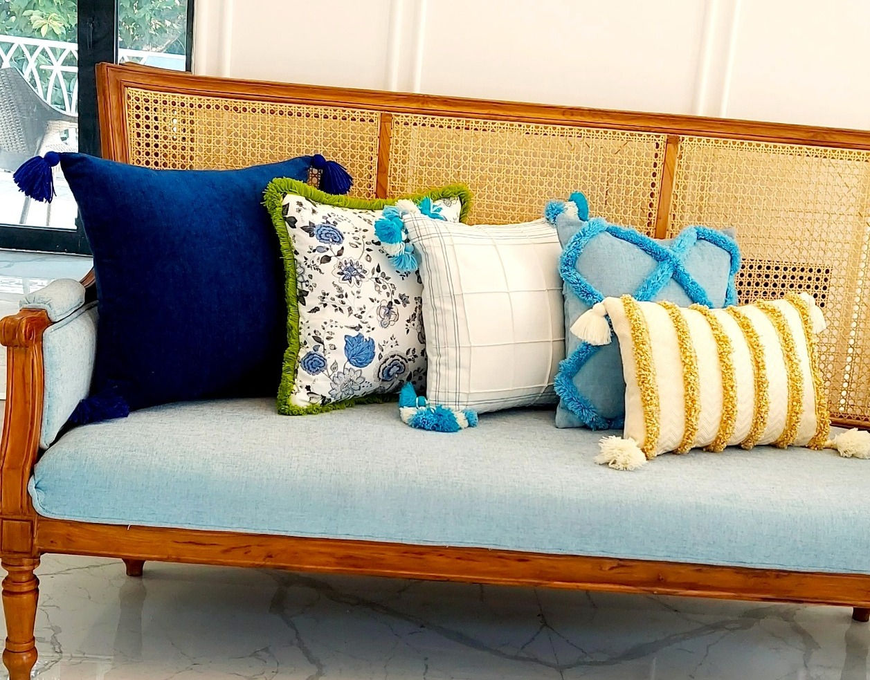 Relax in style with the blue floral cushion cover with green fringe