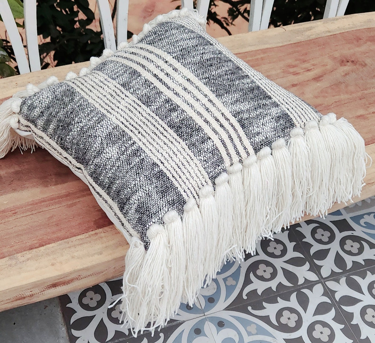 Comfortable and stylish black cushion cover with stripes and tassels