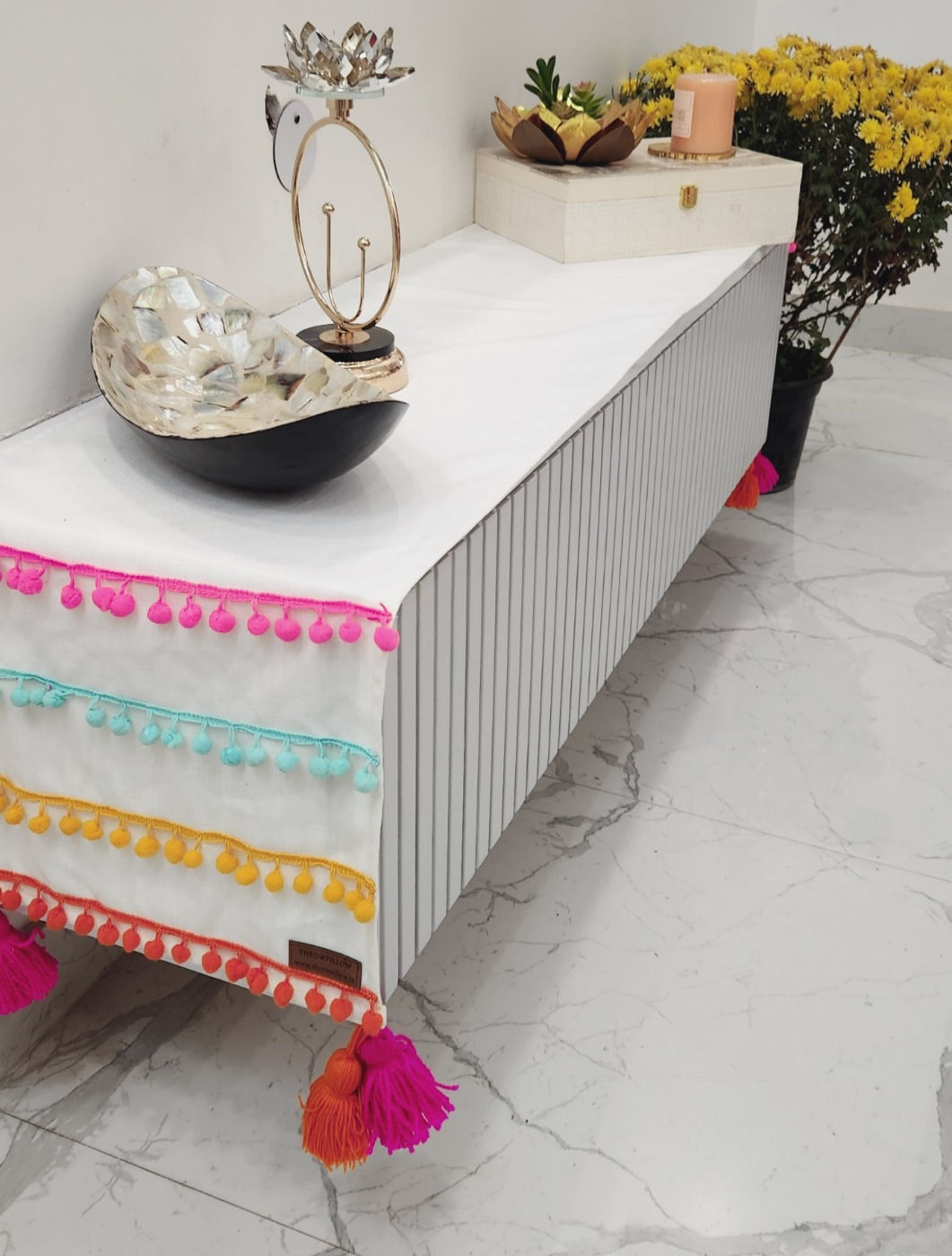 Eye-catching table runner with unique pom-pom lace detailing