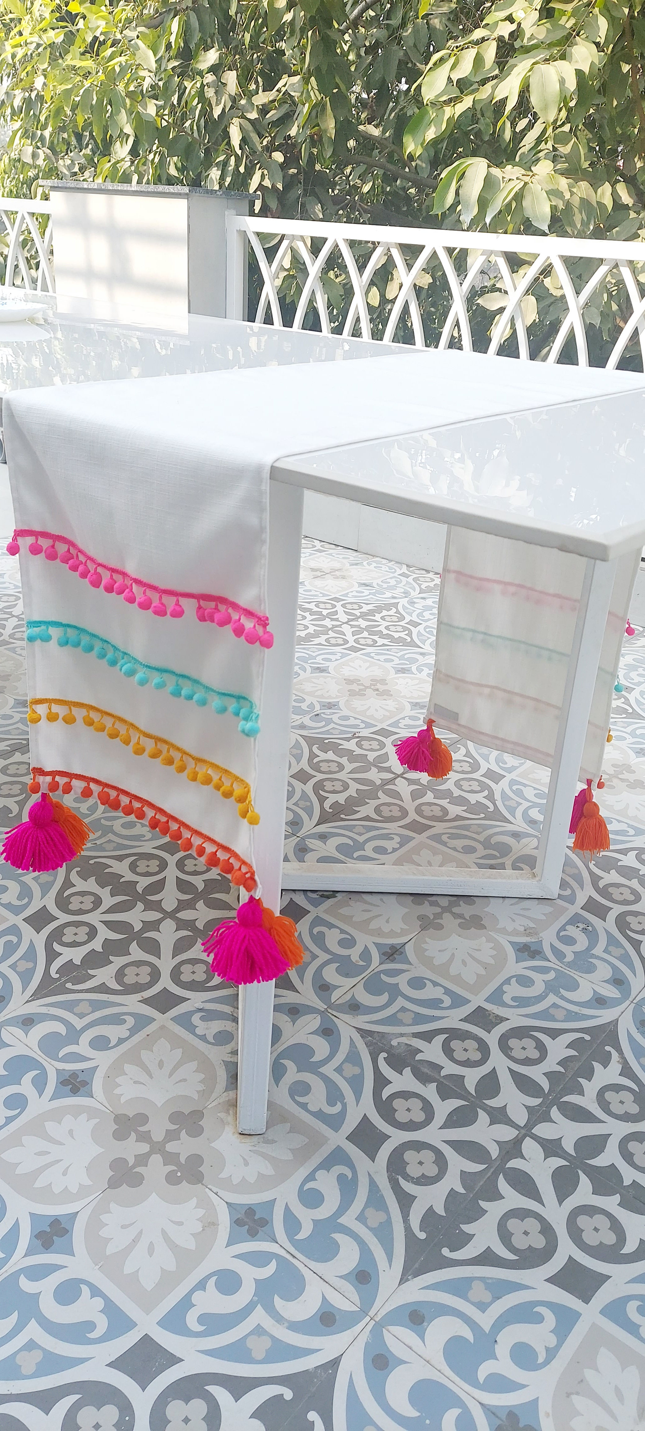 Customer favorite multicolor table runner with pom-pom lace detailing.