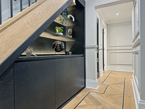 bespoke under stairs unit finished in black bourbon oak with shoe storage drawers