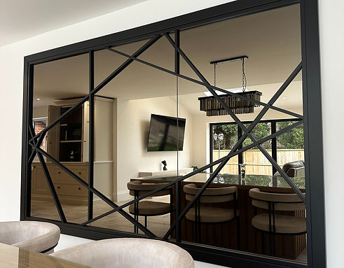 elegant bespoke bronze mirror with black frame and fretwork