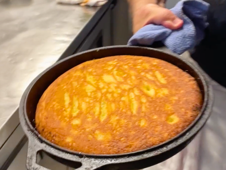 Cornbread in a cast iron skilled, fresh out of the oven