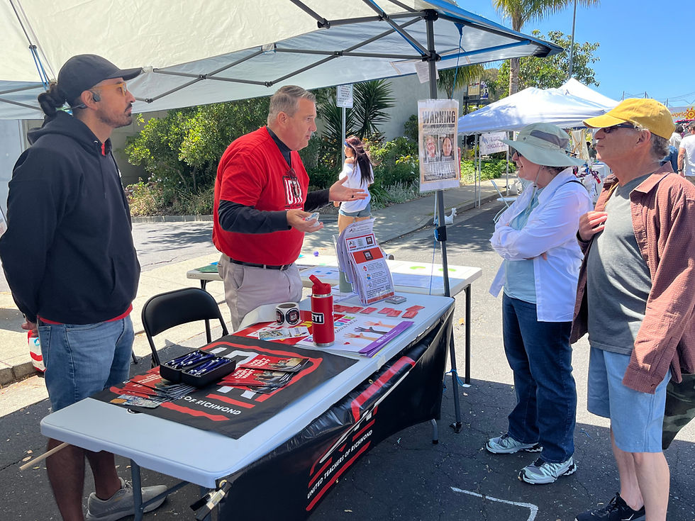 Francisco Ortiz (left) and Mark Mitchell staff a teachers' union table.