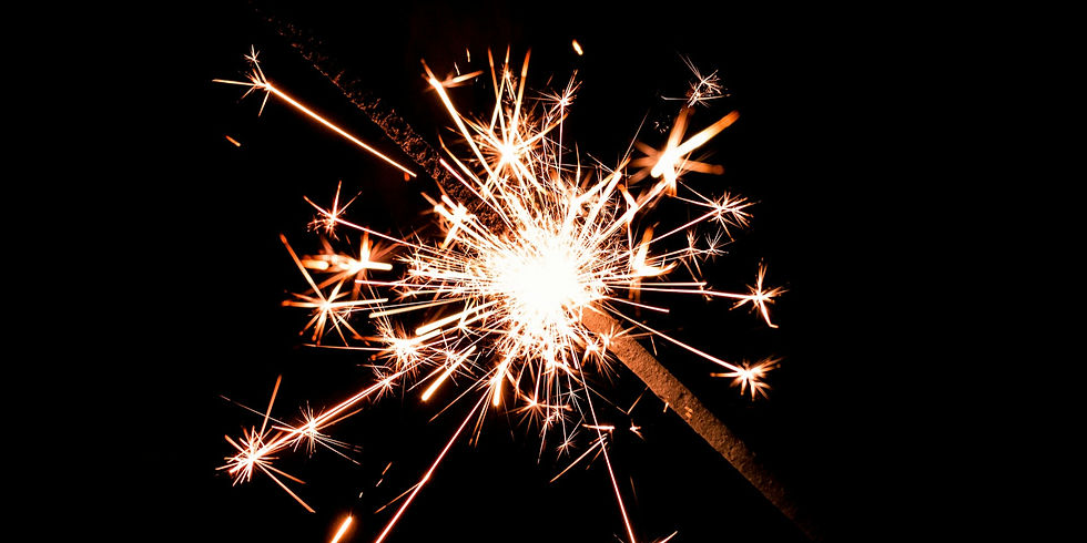 Bright sparkler burning in front of a black background