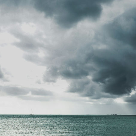 Gray storm clouds over a large body of water