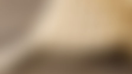 A single wooden domino toppled over and a series of several other dominos cascading behind it