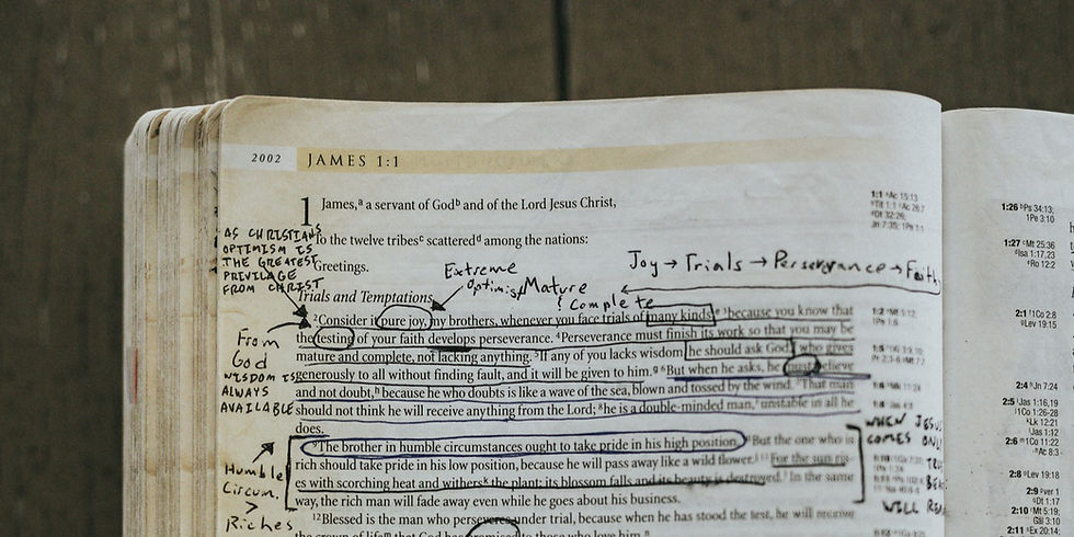 A Bible opened to James 1 covered in notes