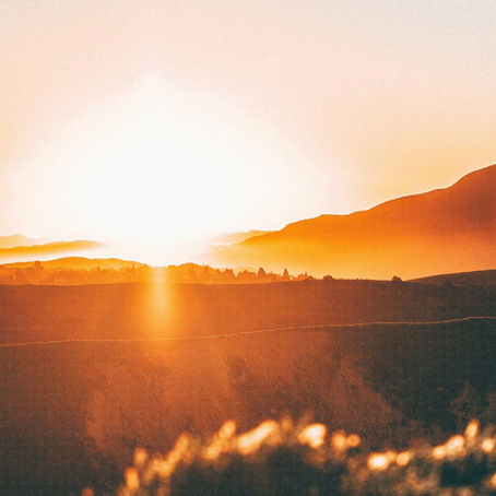 Sunset shining over rolling hills