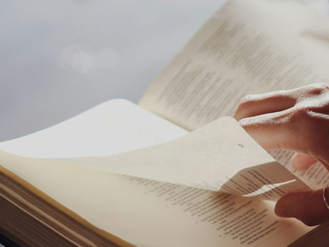 Woman turning Bible page