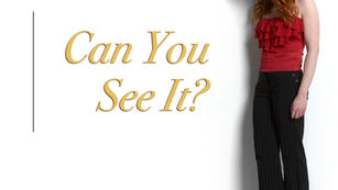 white background gold lettering red head with red hair and red ruffle blouse vintage Bebe, black pin stripe slacks, gazing down at song title Can You See It? Amanda Colleen Williams