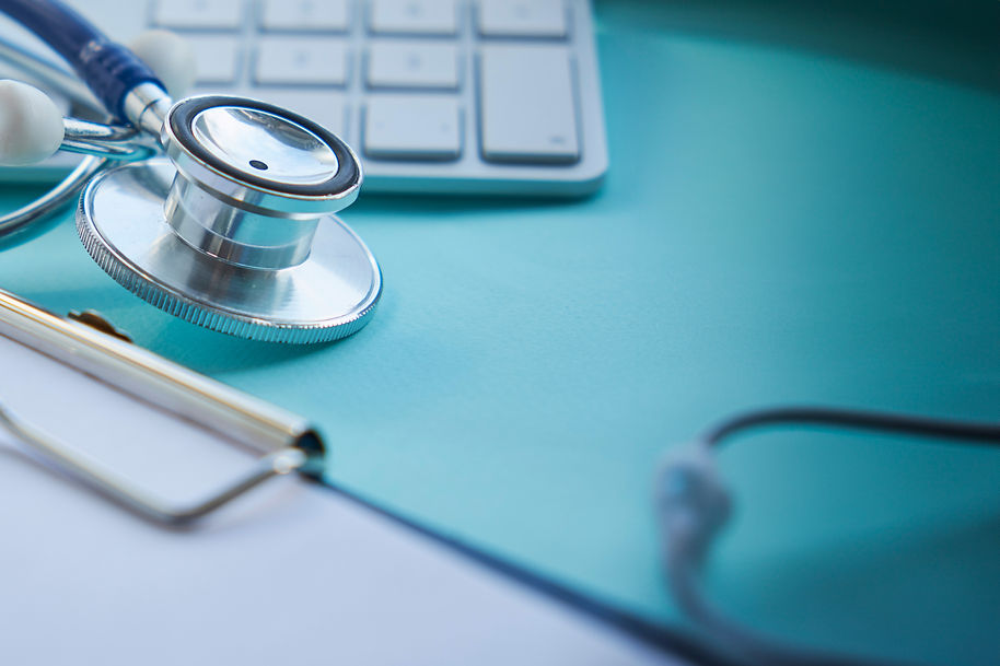 stethoscope-with-clipboard-and-laptop-on-desk-doct-B.jpg