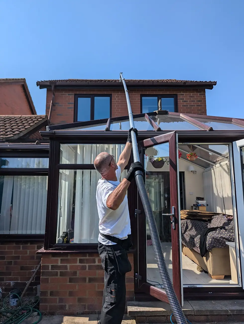 shining windows reaching high level windows with water-fed pole