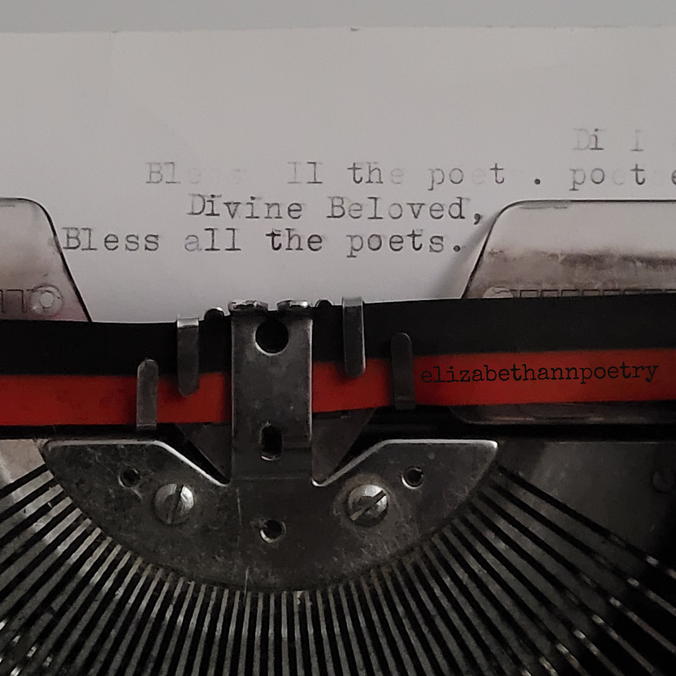 a typewriter with font above the tape that reads Divine Beloved, Bless all the poets. Written by the poet, Elizabeth Ann.