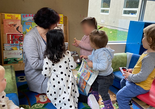 Preschool teacher engaging with children during a play-based activity at Playbox Preschool in Oakville.