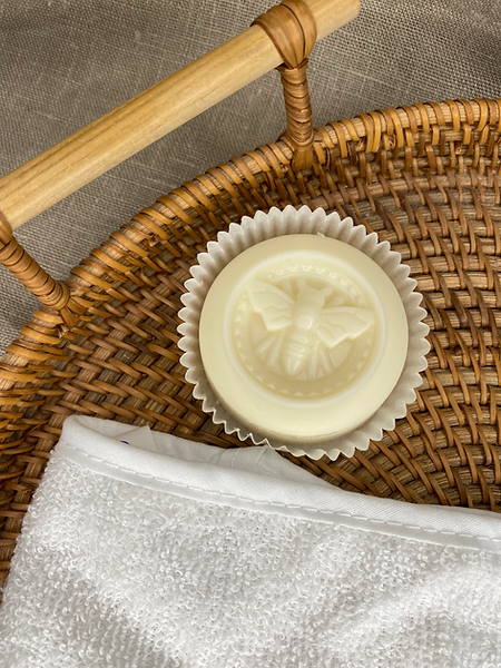 Natural and Organic products, a cream moisturising bar in a wicker basket with a white flannel