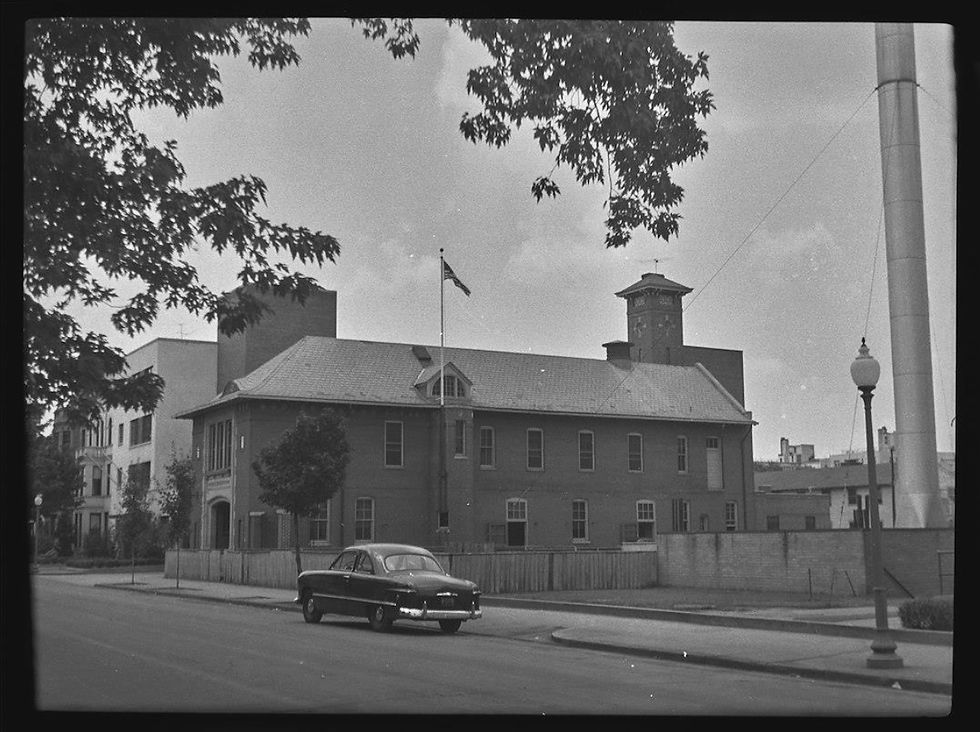 The firehouse from G Street in 1950. Note the "watchtower" in the rear. The George Washington University James Monroe Hall was not built until 1951, allowing this clear view of the firehouse. (DC History Center, John P. Wymer Photograph Collection, July 1950)