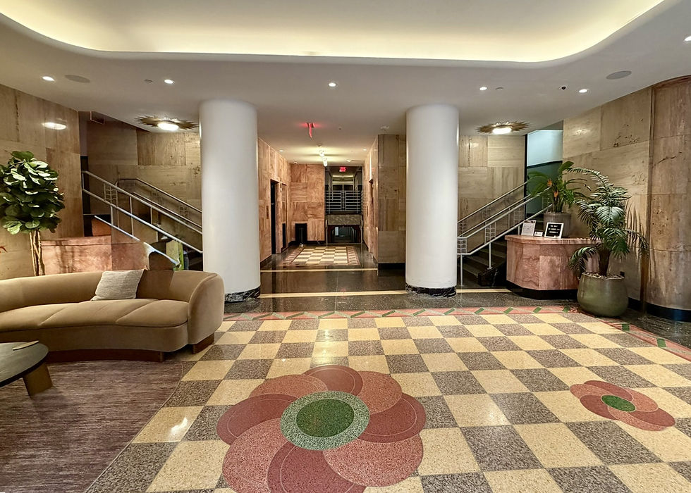 The Wray has a recessed, curved, red granite entryway that “leads into a wonderful lobby area whose walls are constructed of red and yellow granite and accented with beautiful red granite columns. The checker board, two-tone terrazzo floor is inlayed with large red and green flowers of the same material.” (F. Leone, Oct. 2025, description from Art Deco Society)