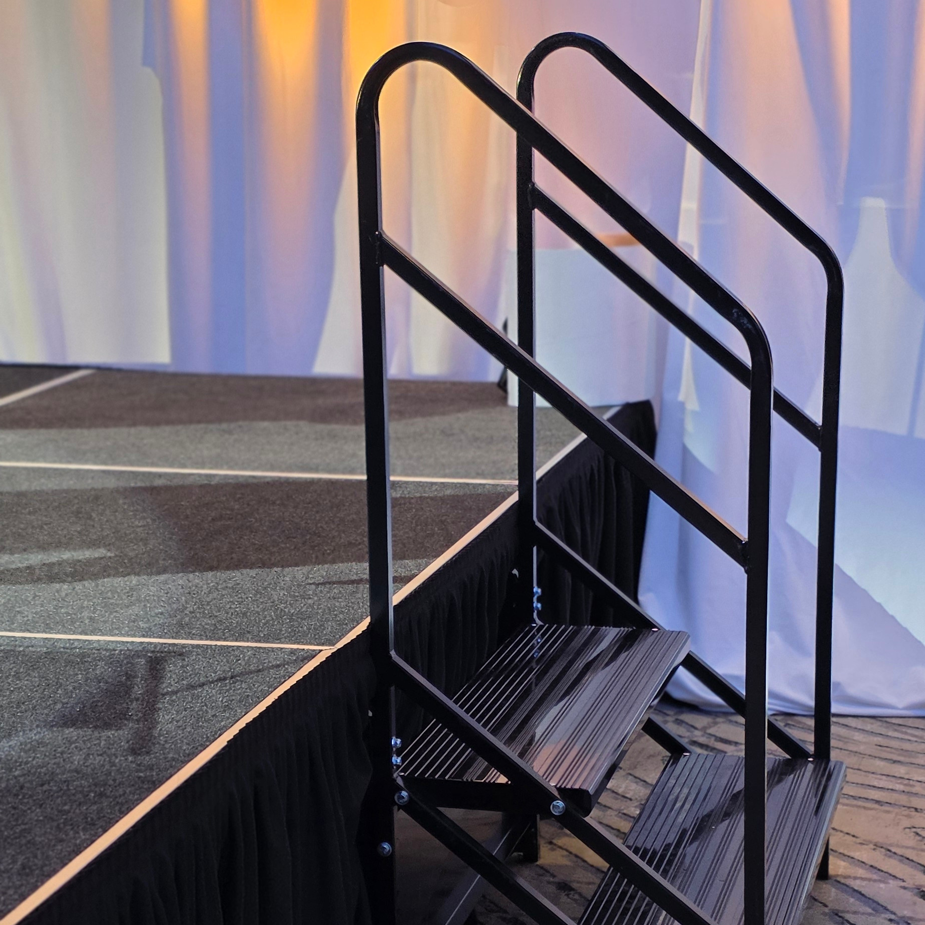 Stacked black modular stage deck panels loaded into a Park City venue entrance by Aspen Peak Productions.