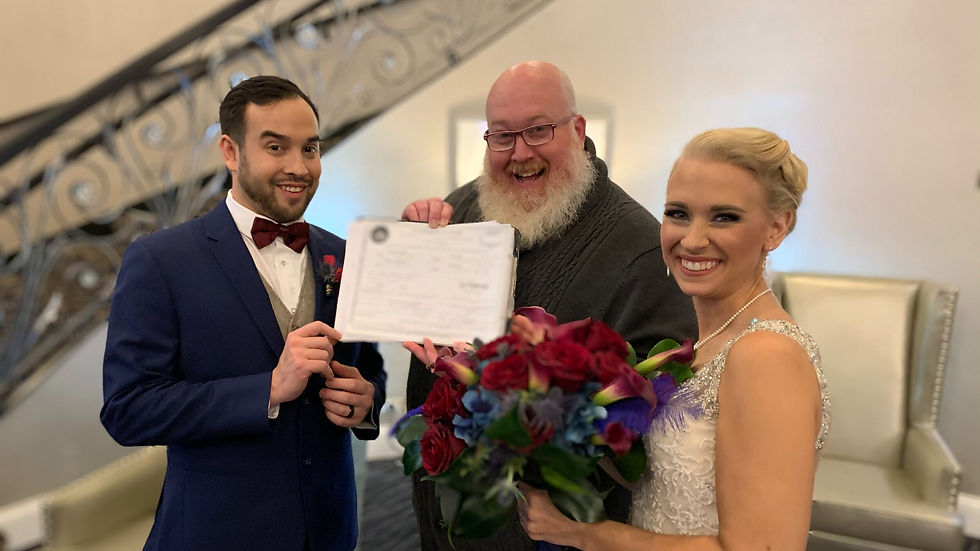 Lead Facilitator Stew presenting a marriage certificate to the bride and groom