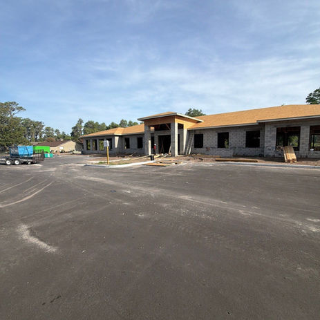 New building under construction with paved lot