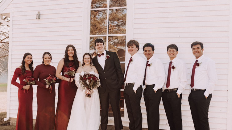 Wedding party group photo outside chapel