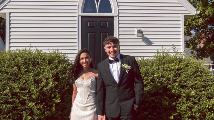 Bride and groom standing outside chapel