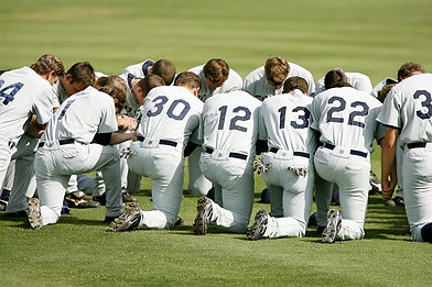 Men's team praying on their knees
