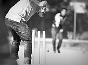 Two people playing cricket.