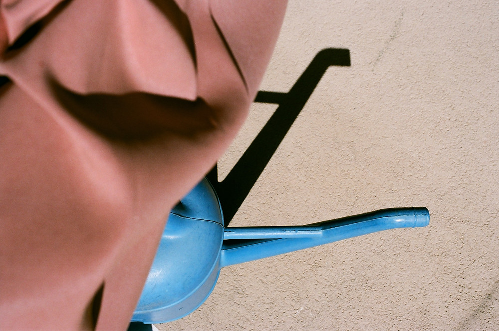 a colorful photo of a blue base of a terracotta umbrella from Lina Scheynius photo-essay for Tabayer Jewelry