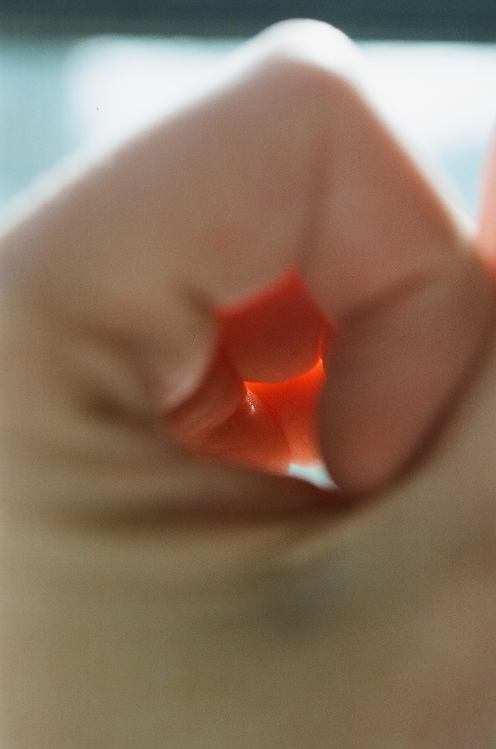 “a blurred photograph of blood orange wedges on a dark background from Lina Scheynius photo-essay for Tabayer jewelry