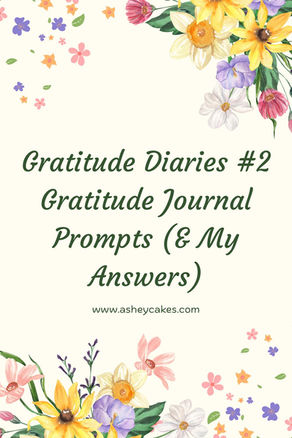 Floral border with colorful flowers on a light background. Text: "Gratitude Diaries #2, Gratitude Journal Prompts (& My Answers)," www.asheycakes.com.