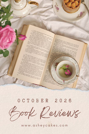 Cozy flat lay of open book, teacups, cake and pink flowers on white cloth, with text October 2026 Book Reviews www.asheycakes.com