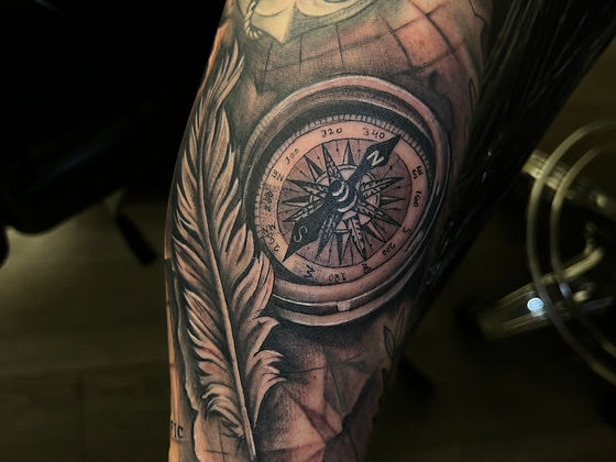 compas tattoo feather