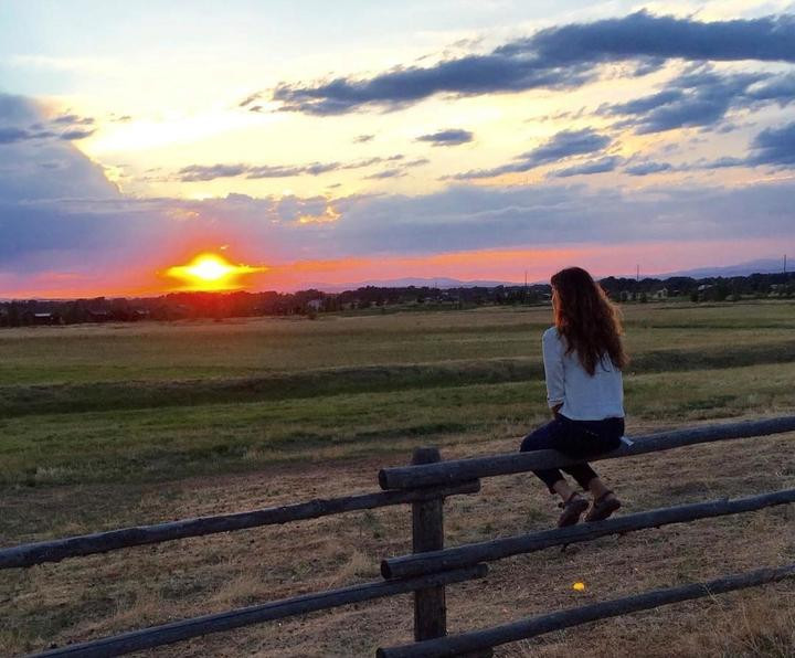 Cassie is watching the sunset on the plain