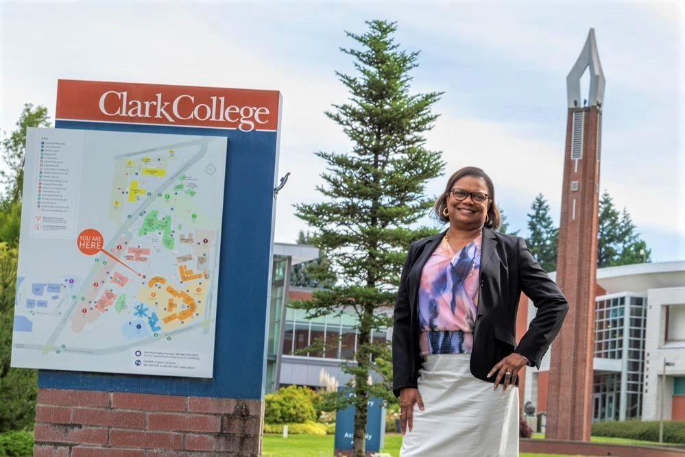 Karin Edwards is standing next to the Clark College directory
