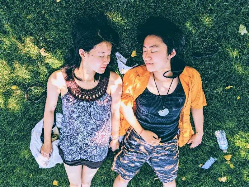 Two women lying on the grass