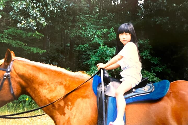 Little Holly is riding a horse