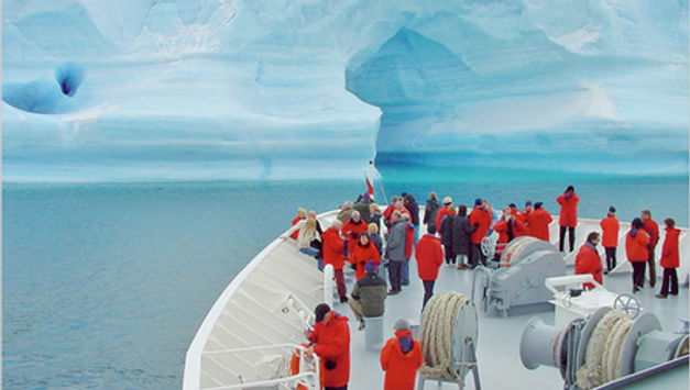 “If Antarctica were music, it would be Mozart. Art, and it would be Michelangelo. And yet, it is something even greater; the only place on Earth that is still as it should be. May we never tame it” (Denton, 2011). Contrary to this wish, however, the reality seems to unfold differently. Although Antarctica is the least visited continent –as it was just discovered in 1820- the level of tourist visitation has been increasing over the last few decades, and the expectation is that Antarctic tourist numbers will trend upward (Verbitsky, 2013). To meet consumers’ growing desire for natural, authentic experiences, tour operators conform to this trend by developing travel packages of “alternative” tourism to new “undiscovered” destinations (Student et al., 2016, p. 2). This newfound direction has sparked numerous discussions regarding the most effective practice to meet the many-faceted challenges of sustaining the physical habitat while providing an appropriate visitor experience. By delving into the historical aspect of the development of Antarctic tourism, an attempt will be made to retrieve answers to the contemporary controversy about the impacts of the tourists’ presence on the continent. Figure 1: Tourists are approached by a curious Emperor penguin chick (Duffy, 2009). The Course of Antarctic Tourism As early as the 1920s, Thomas Cook identified Antarctica as a potential tourist resort and proceeded to organise cruises, which did not appeal to a wide audience (Headland, 1994). The first to make tourism in Antarctica successful was "Lars-Eric Lindblad, who in the 1950s and 1960s specialised in taking small parties of aristocrats to unconventional destinations" (Gargiulo, 2017). Lindblad's pattern based on cruises from South America, Australia and New Zealand worked well for Antarctica and soon became cheaper, shorter, and more abundant (Gargiulo, 2017). Gradually, the image of Antarctica as an enchanting frozen world, well worth anyone’s attention and money to visit, was established. Over the last four decades, the budding tourism industry has grown. Even though it can mainly be described as shipborne, it is also constituted by adventure activities ashore and is characterised by the recent redevelopment of overflights. Especially after the 1990s, between mid-November and early March, when the ice conditions are milder, the number of voyages increased as tourism operators responded to the growing demand for Antarctic tourism (Snyder, 2007). The growth in aircraft capacity, combined with a relative decrease in the cost of air travel, as well as a rise in disposable time and income, have prompted more people than ever before to visit faraway places. As a result, the number of tourists who visited the continent annually began to rise sharply, and within twenty years, the numbers had increased by more than six hundred percent (IAATO, n.d.). Figure 2: Antarctic tourism numbers over the last decades (Lamers, 2017). Tourist activity is concentrated on cruise ship and flight operations in the Antarctic Peninsula and, to a lesser extent, the Ross Sea (Hall, 1992). According to the UNWTO annual reports, between 2,500 and 3,000 people visited the Antarctic each year over the past decade (The Antarctic Treaty, n.d.). As far as the profits made are concerned, although the numbers may be considered limited, the industry is worth almost $308M (£206M) a year; this is probably a low estimate considering that “deep field” trips, which cover the great area of the South Pole, cost tourists more than $50,000 (£33,550) (Marshall, 2016). Tourism Industry: Not “Cool” Enough for the Antarctic? With regard to the conduct of tourism in Antarctica and the ethical implications surrounding it, many debates have been ignited for the last few years. As far as the legitimacy of Antarctic tourism is concerned, various opinions have been expressed. The Australian Wilderness Society and the Australian Conservation Foundation (ACF) promote policies that would hinder any tourism from taking place in Antarctica (ACF, 2016), raising philosophical questions about whether the human race has the right to intrude on every part of the globe just because it is technically feasible. In addition, further questions are raised on whether tourism is a positive activity. Unlike most other destinations, where tourism is accepted as a form of economic development for the local population's improvement of living standards, there is no such justification in Antarctica. Without the local people, it can be claimed that only tourists and tourism operators benefit directly from this activity (Lamers, 2012). An example demonstrating this one-sided advantage is the growing demand to use drones to take photos, although the International Association of Antarctica Tour Operators (IAATO) has currently banned them for recreational use (IAATO, 2019). Figure 3: Tourists and scientists are coming into increasing contact with Antarctic penguins (Mint Images, 2018). Substantial concerns also exist about tourism's impacts on Antarctica's cultural heritage since there is no government presence at the site to ensure that no damage occurs or that artefacts are not stolen  (ICOMOS, 2022). The cultural heritage of the region is mainly of interest to tour operators. Several cultural and industrial (sealing and whaling) sites exist in the Antarctic Peninsula and on the sub-Arctic islands, and "several early exploration bases are of substantial historic significance, such as the nineteenth-century sealers’ sites in the South Shetland Islands and the historically significant Mawson’s Huts" (Hall, 1992). Nevertheless, the most prominent issue surrounding tourism in Antarctica is the potential impact of tourism on the Antarctic environment, meaning the harvesting of marine life or the potential effect of oil and mineral exploration and extraction. Furthermore, the length of time visitors spend on land and their activities need further clarification, particularly as "ship-based tourism is extremely hard to regulate because of the mobility of cruise operations and their capacity to visit remote locations" (Hall, 1992). Furthermore, "cruise travel in the Antarctic summer coincides with the peak breeding periods for many species" (Hall, 1992) and may disturb wildlife breeding sites that are a key feature of the touristic attractiveness of Antarctica. Figure 4: Current regulations mandate how close visitors to Antarctica can get to its wildlife (Marshall, 2016). In addition, "ships can freely pollute over a wide area through indiscriminate disposal of intractable wastes and sewage" (Hall, 1992), while oil spills resulting from damage in the poorly charted Antarctic waters would have a significant influence on fragile ecosystems. Permanent onshore facilities and infrastructure have been reported to have the greatest impact on the Antarctic environment since early 2000 (Bastmeijer et al., 2008). Establishing tourism facilities poses major problems with sewage and waste disposal, food and water supply, and the provision of accommodation facilities associated with tourism operations. The increasing concerns about environmental degradation can be attributed to the fact that the Antarctic is the last remaining near-pristine continental wilderness and is regarded as a laboratory of global scientific importance for researching ozone depletion, climatic history, and global warming (Cool Antarctica, n.d.). The Polar-Opposite View Figure 5: A minke whale emerges near Zodiac boats carrying Lindblad Expeditions passengers in Paradise Bay, Antarctica (Nolan, 2021). A strong sentiment has arisen in support of tourism as a means to save “save Antarctica” (Dunning, 2018), in contrast to an exclusively negative perspective. This stance is spread among well-educated travellers familiar with its resources. Their voices would be heard, therefore, in defence of conservation policies. A growing number of operators support that keeping some places on Earth out of bounds for tourism will often simply obscure challenges. Tourists can witness the ongoing changes in the Antarctic waters caused by climate change and further help raise awareness when they get home (Marshall, 2016). It has been further argued that Antarctica, with its wild nature, can even serve as a breeding ground for female empowerment to be displayed (IAATO, 2021). Female figures that stood up against adverse  Antarctic conditions constitute inspiring examples of female perseverance and fierceness. Pat Falvey led an Irish team to reach the South Pole in August 2007, and Clare O'Leary in 2008 became the first Irish female to reach it. Similarly, Felicity Aston became the first person to ski alone across Antarctica, as well as the first woman to cross Antarctica alone in 2012 (Kiniry, 2022). Despite the anticipated growth in tourists’ interest in the Antarctic, there is surprisingly little opposition from scientists to Antarctic tourism. Many representatives of the Scientific Committee on Antarctic Research at intergovernmental meetings have expressed optimistic views on the topic, stating that, despite the well-known risks, tourism will be well managed into the foreseeable future (SCAR, n.d.). It has been admitted that the prime strategy of the tourism industry is to capitalise on the country's unique features. This way, it ensures a marketable product and lowers the risk of competition from other destinations. To maintain their competitive edge, tourist destinations have been forced to search for types of tourism developments with the least negative effects on social and natural environments. Sustainable and socially conscious tourists have been associated with higher socioeconomic standing and are thought to spend more than their mass-tourism counterparts ( World Travel & Tourism Council, 2016) . Under this prism, the tourism industry often claims to support and enhance wilderness preservation, habitat maintenance, and the establishment of national parks. Figure 6: The Consultative Meeting is the official deliberation forum of the Antarctic Treaty (Merco Press, 2010). The Tip of the Iceberg? However, in the Antarctic context, the long-term environmental impacts of tourism on natural resources still need to be determined because scarce scientific tools are available to detect subtle changes, such as alterations in the reproduction rates or the composition of plant species.  Establishing a comprehensive regulatory and management framework for the continent's tourism is complex because it involves a high level of international cooperation between the Antarctic Treaty Consultative Parties and those segments of the travel industry directly involved in Antarctica tours (The Antarctic Treaty, n.d.). This government-industry interaction is an unprecedented experiment whose success remains questionable. An additional logistic concern is Antarctic shipping control, particularly given the possible introduction of larger cruise liners to take more significant numbers of tourists. Thus, there is a greater risk of shipborne tourism impacts. Therefore, a freight convention on shipping activities in the Antarctic and sub-Antarctic waters must be established. This would ensure that vessels meet the minimum necessary safety and operational standards (The Antarctic Treaty, n.d.). Figure 7: Australia's research and supply vessel, the RSV Nuyina, in Newcomb Bay, Antarctica (Ryan, 2022) Conclusions Despite being a virtually uninhabited landmass, Antarctica has experienced many-fold visitor increases over the last few decades. Given the newfound and growing tourist presence, various dilemmas have been raised regarding the legitimacy of Antarctic tourism. Could the ice breaker in this relationship cause the melting of Antarctica? For example, considering that tourism is already well established on the continent and that tourism activities may aggravate parts of the Antarctic ecosystem, the need to investigate current and future trends in the sustainability of commercial tourism operations comes to the forefront. The commercial and national interests, which are becoming increasingly active in Antarctic tourism, will play a significant role in determining the management and policy framework that will regulate the flow of visitation to the continent. Bibliographical References Australian Conservation Foundation. (2016). We stopped mining in Antarctica . https://www.acf.org.au/antarctica  Bastmeijer, K., Lamers, M., Harcha, J. (2008). Permanent land-based facilities for tourism in Antarctica: The need for regulation. Review of European Community and International Environmental Law, 17. DOI: 10.2139/ssrn.1766407 Cool Antarctica. (n.d.). Protecting the Antarctic environment conservation. https://www.coolantarctica.com/Antarctica%20fact%20file/science/conservation.php  Denton, A. (2011).  Andrew Denton & Jennifer Byrne. Chimu Adventures. https://www.chimuadventures.com/en/antarctica/guest/Denton-Byrne  Dunning, M. (2018). How to save Antarctica (and the rest of Earth too) . Imperial College London .  https://www.imperial.ac.uk/news/186668/how-save-antarctica-rest-earth/  Gargiulo, F. (2017). A brief history of Antarctic tourism. Wayfinders. overflight://wayfinderadventures.com/antarctic-tourism/  Hall, C. M. (1992). Tourism in Antarctica: Activities, impacts, and management. Journal of Travel Research, 30( 4), 2–9. https://doi.org/10.1177/004728759203000401  Headland R. (1994). Historical development of Antarctic tourism. Annals of Tourism Research, 21 (2), pp. 269-280. https://doi.org/10.1016/0160-7383(94)90044-2.  IAATO (n.d.) Visiting Antarctica . https://iaato.org/visiting-antarctica/  IAATO. (2019). IAATO Announces new restrictions on drone use by visitors. https://iaato.org/iaato-announces-new-restrictions-on-drone-use-by-visitors/  IAATO. (2021). Look no further than the Antarctic community to inspire girls into STEM. https://iaato.org/blog/look-no-further-than-the-antarctic-community-to-inspire-girls-into-stem/  ICOMOS. (n.d.). Antarctic archaeological guidelines provide tailored guidance for heritage conservation in Antarctica. https://www.icomos.org/en/89-english-categories/home/113669-draft-doctrinal-texts-aga-2022  Kiniry, L. (2022). Ten Pioneering Women of Antarctica and the Places Named for Them. Smithsonian Magazine.  https://www.smithsonianmag.com/travel/ten-pioneering-women-of-antarctica-and-the-places-named-for-them-180979812/  Lamers, M. (2012). Strategic challenges of tourism development and governance in Antarctica: taking stock and moving forward. Polar Research, 31. DOI: 10.3402/polar.v31i0.17219  Marshall, A. (2016). Antarctica's tourism industry is designed to prevent damage, but can it last? The Guardian. https://www.theguardian.com/world/2016/jun/26/antarctica-tourism-regulations-cruises-field-trips  Scientific Committee on Antarctic Research. (n.d.). Strategic plans. https://www.scar.org/strategic-plans/  Secretariat of the Antarctic Treaty. (n.d.). Tourism and non-governmental activities. https://www.ats.aq/e/tourism.html  Snyder, J. (2007). Tourism in the polar regions: The sustainability challenge.  Bernard Stonehouse. Student, J., Amelung, B., Lamers, M. (2016). Towards a tipping point? Exploring the capacity to self-regulate Antarctic tourism using agent-based modeling. Journal of Sustainable Tourism, 24. https://www.researchgate.net/publication/292962518_Towards_a_tipping_point_Exploring_the_capacity_to_self-regulate_Antarctic_tourism_using_agent-based_modelling  Verbitsky, J. (2013). Antarctic tourism management and regulation: The need for change. Polar Record, 49 (3), 278-285. https://www.cambridge.org/core/journals/polar-record/article/abs/antarctic-tourism-management-and-regulation-the-need-for-change/294C2BCFC7B5AED3A6795D164AB4B040  World Travel & Tourism Council . (2016). How national parks around the world influenced sustainable tourism development.  Medium.  https://worldtraveltourismcouncil.medium.com/how-national-parks-around-the-world-influenced-sustainable-tourism-development-6e149cfc0688  Visual Sources Cover image: Hapad Lloyd Cruises. (2009). Growth of Antarctic tourism [Photograph]. The New York Times. https://www.nytimes.com/2008/02/17/travel/17cold.html  Figure 1: Duffy, I. (2009). Tourists are approached by a curious Emperor penguin chick  [Photograph]. Flickr. https://www.flickr.com/photos/ianduffy/4323701364/  Figure 2: Lamers M. (2017). Antarctic tourism numbers over the last decades  [Graph]. ResearchGate. https://www.researchgate.net/figure/Antarctic-tourism-numbers-based-on-data-obtained-from-IAATO-2017_fig6_325763631  Figure 3: Mint Images (2018). Tourists and scientists are coming into increasing contact with Antarctic penguins  [Photograph]. Science. https://www.science.org/content/article/tourists-may-be-making-antarctica-s-penguins-sick  Figure 4: Marshall, A. (2016). Current regulations mandate how close visitors to Antarctica can get to its wildlife  [Photograph]. The Guardian. https://www.theguardian.com/world/2016/jun/26/antarctica-tourism-regulations-cruises-field-trips?fbclid=IwAR0isfCw0AtdsFBO-8tfa4-R0GKP2dVX9AfggPM50VdyB6TeRF0C6jaTeZQ  Figure 5: Nolan, M.S. (2021). A minke whale emerges near Zodiac boats carrying Linblad Expeditions passengers in Paradise Bay, Antarctica. [Photograph]. The Spokesman-Review. https://www.spokesman.com/stories/2021/apr/24/a-fragile-system-underpins-antarcticas-booming-tou/  Figure 6: Merco Press (2010). The Consultative Meeting is the official deliberation forum of the Antarctic Treaty. [ Photograph]. MercoPress. https://en.mercopress.com/2010/05/03/annual-antarctic-treaty-conference-opens-monday-in-uruguay  Figure 7: Jackson R. (2022). Australia's research and supply vessel, the RSV Nuyina, in Newcomb Bay, Antarctica.  [Photograph]. CNET. https://www.cnet.com/science/climate/antarctica-is-melting-faster-thanks-to-pollution-from-tourism-and-research/