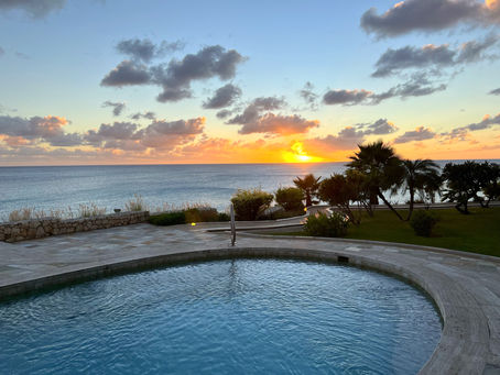 Caribbean sunset over the ocean in Cupecoy, Sint Maarten, viewed from the island's southwestern coastline.