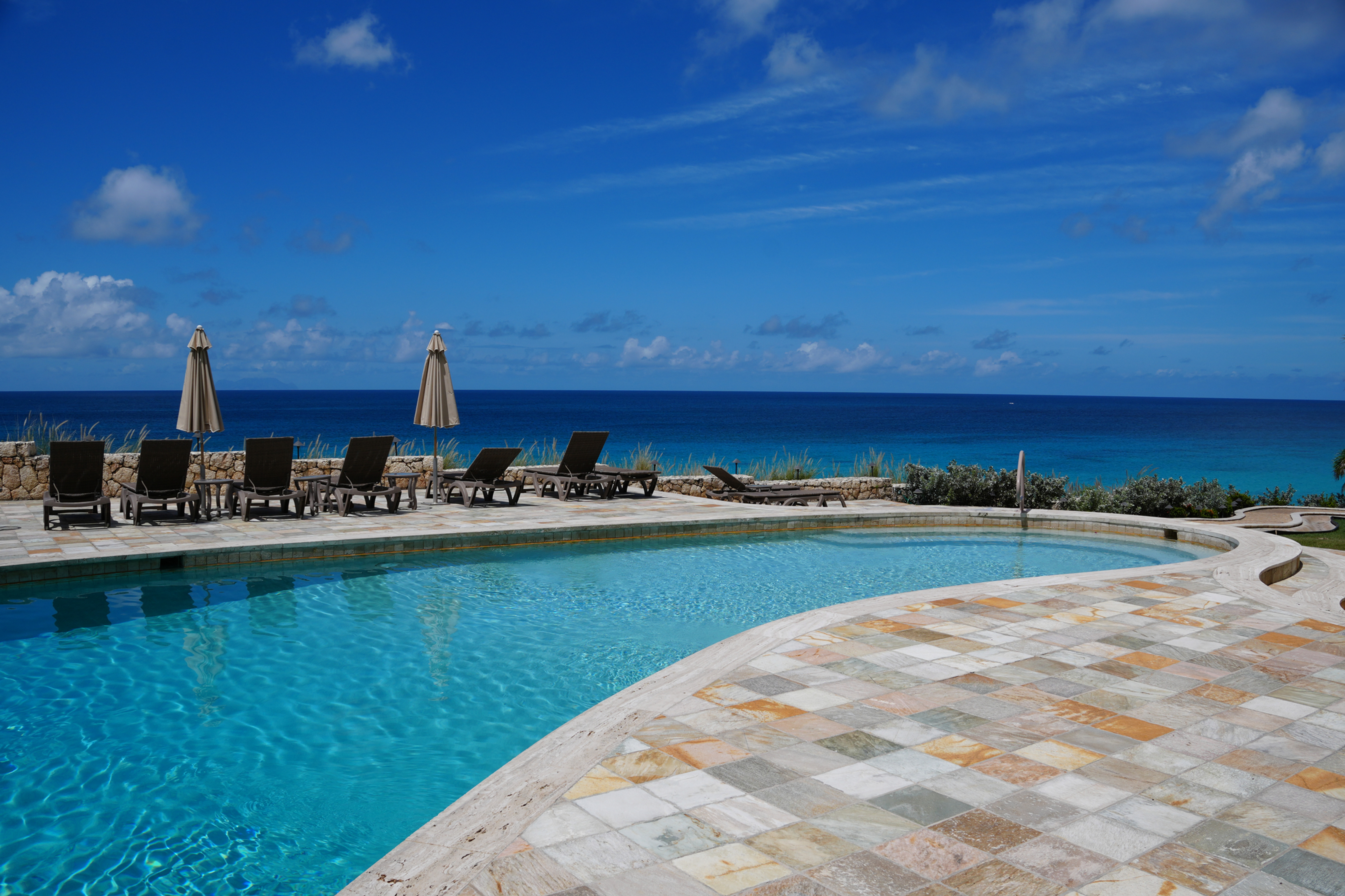 Oceanfront swimming pool at Premium at Rainbow Beach Club in Cupecoy, Sint Maarten, overlooking the Caribbean Sea.
