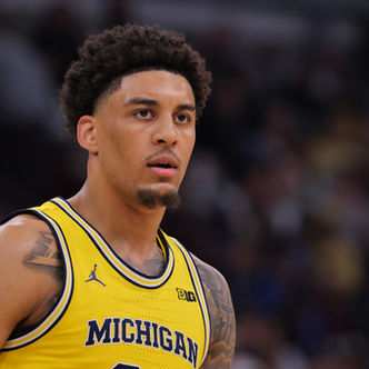 Yaxel Lendeborg looks on while wearing Michigan’s No. 23 jersey during a college basketball game.