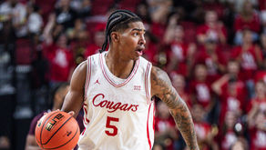 Chris Cenac Jr. dribbles the ball for the Houston Cougars during a college basketball game.