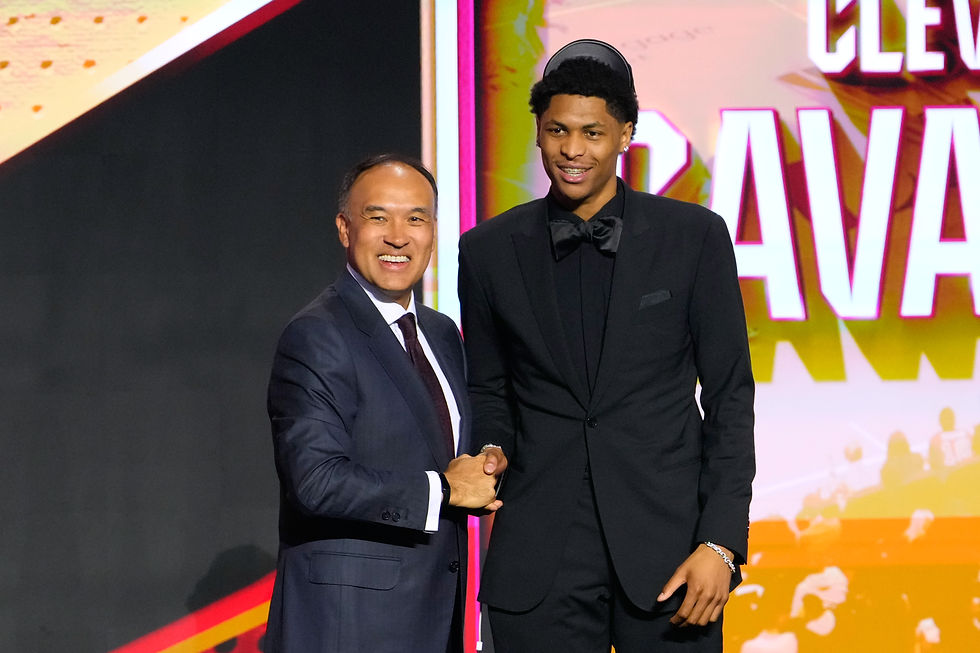 Meleek Thomas poses on stage after being selected in the 2026 NBA Draft.