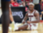 Ryan Conwell of the Louisville Cardinals reacts after a play during a college basketball game.