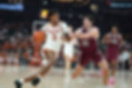 Dailyn Swain of the Texas Longhorns drives to the basket in a college basketball game.
