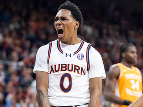 Auburn's Tahaad Pettiford dunks the ball during a college basketball game.